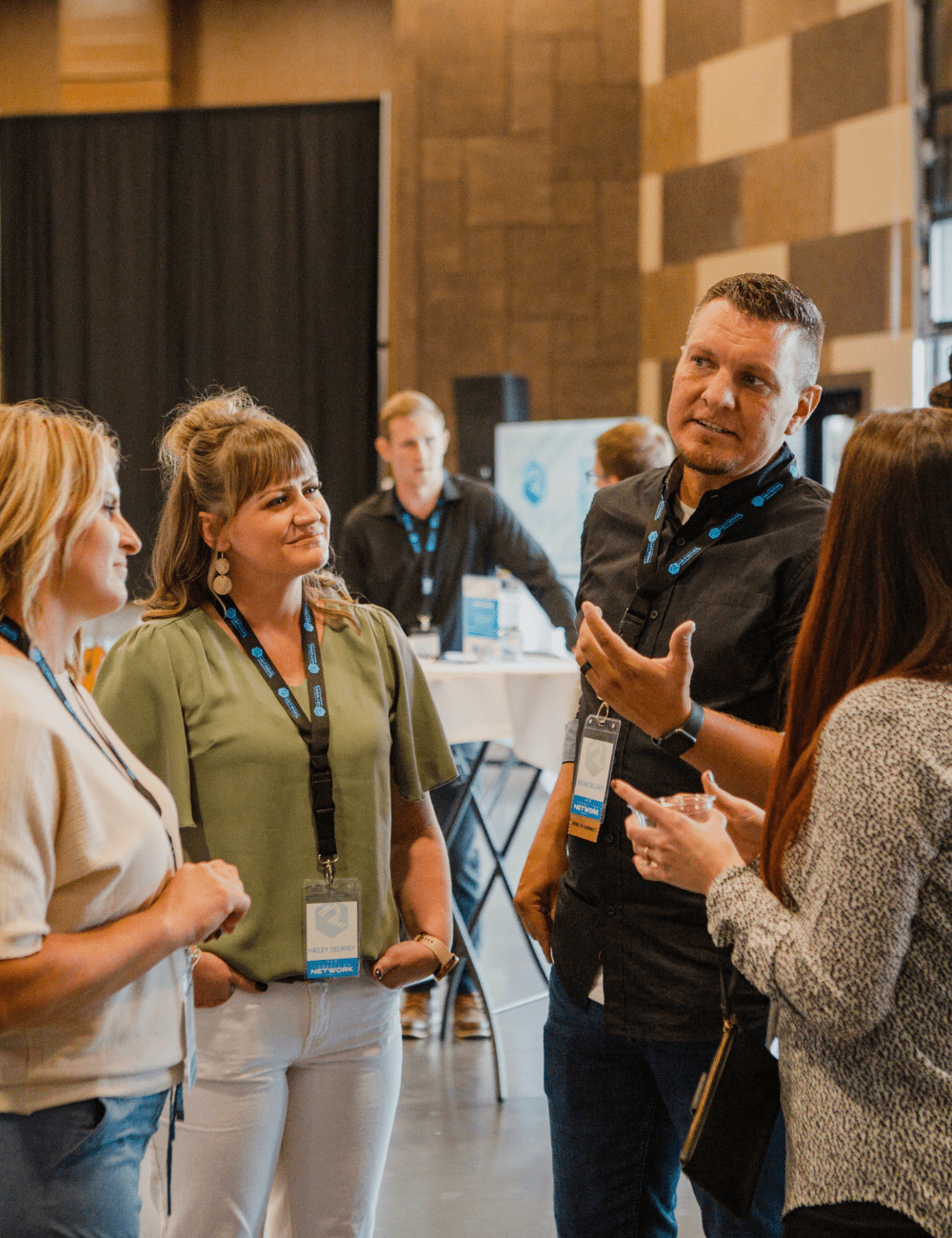 Man Mingling with Three Business Women at RizeX Idaho Networking Event